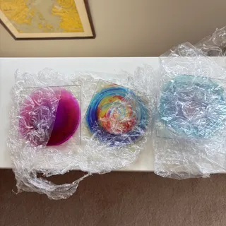 Photo of 4 unopened/ unused custom glass coasters by San Diego artist