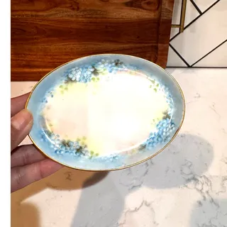 Photo of vintage hand-painted porcelain trinket dish blue floral motifs subtle gold trim