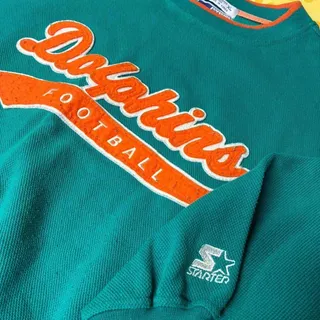 Photo of Check out this essential vintage 90s Miami Dolphins sweatshirt by Starter